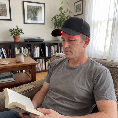 Amal Red Light Growth Cap, worn while reading